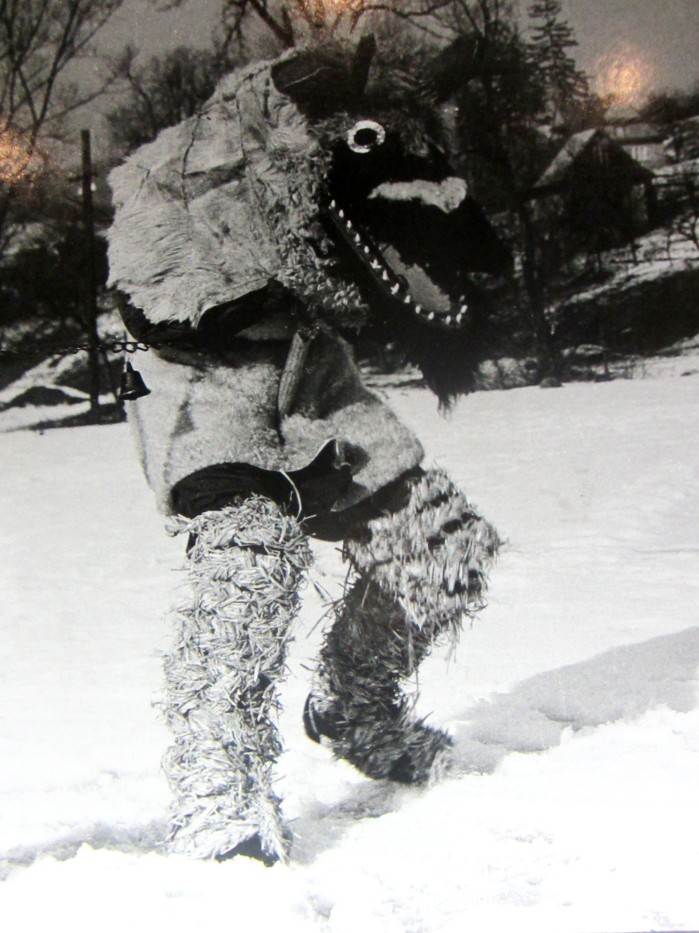 A caroler dressed as an animal puppet